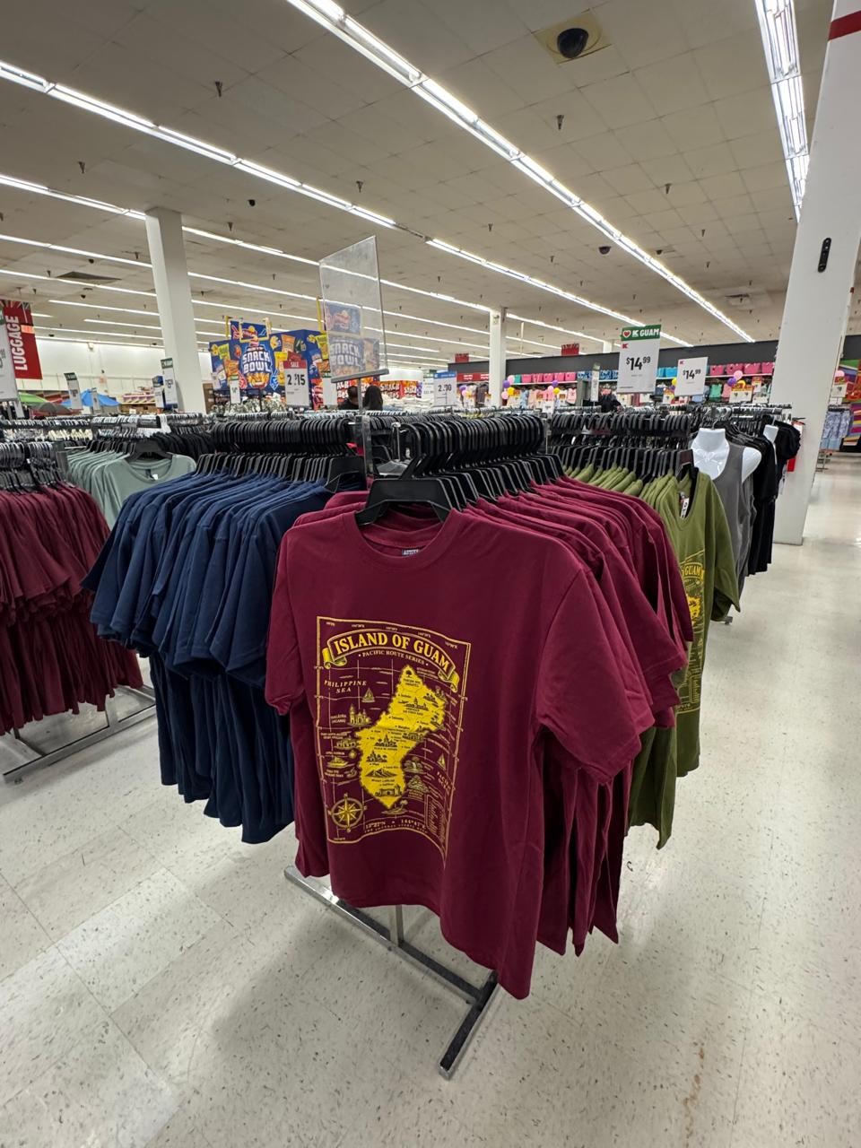 Island of Guam map t-shirts in burgundy, navy blue and green on the rack at Kmart Guam